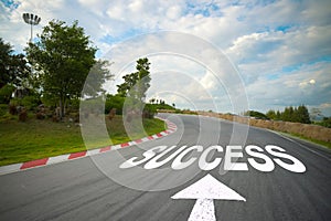 Business concept picture of success and road arrow direction sign on the asphalt road