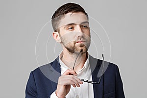 Business Concept - Portrait of a handsome businessman in suit with glasses serious thinking with stressful facial expression. Isol