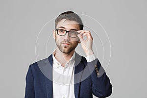 Business Concept - Portrait of a handsome businessman in suit with glasses serious thinking with stressful facial expression. Isol