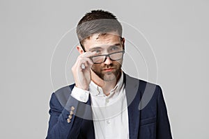 Business Concept - Portrait of a handsome businessman in suit with glasses serious thinking with stressful facial expression. Isol