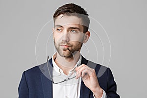 Business Concept - Portrait of a handsome businessman in suit with glasses serious thinking with stressful facial expression. Isol