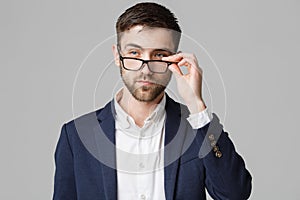 Business Concept - Portrait of a handsome businessman in suit with glasses serious thinking with stressful facial expression. Isol