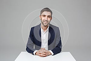 Business Concept - Portrait handsome happy handsome business man in suit smiling and siting in work office. White