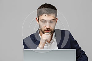 Business Concept - Portrait handsome stressful business man in suit shock looking at work in laptop. White Background.