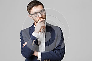 Business Concept - portrait young successful businessman posing over dark background. Copy space.