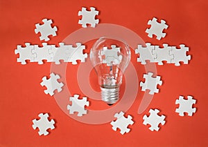 Business concept,recruitment,human resources,innovation, team building.Light bulb and jigsaw puzzle with one piece missing. Free