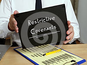 Business concept about Restrictive Covenants with phrase on the piece of paper