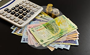 Business concept, Romanian currency on black table. LEI banknotes, coins and calculator photo