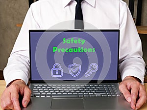 Business concept about Safety Precautions with inscription on the page