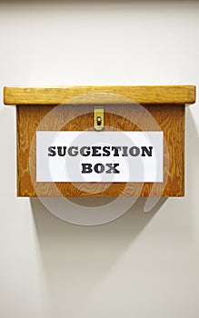 Business Concept Shot Of Wooden Suggestion Box On Wall In Office