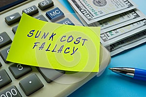 Business concept about SUNK COST FALLACY with phrase on the sheet