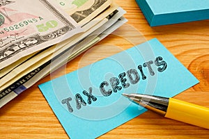 Business concept about TAX CREDITS with phrase on the piece of paper