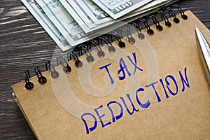 Business concept about TAX DEDUCTION with sign on the sheet