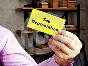 Business concept about Tax Depreciation with sign on the yelow business card