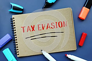 Business concept about TAX EVASION with inscription on the sheet