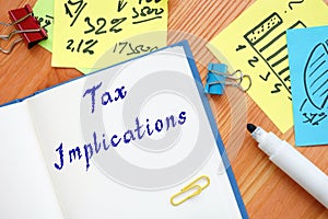 Business concept about Tax Implications with inscription on the sheet