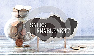 Business Concept.Text SALES ENABLEMENT writing on wooden puzzle with pencil