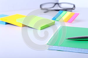 Business concept. Top view of kraft spiral notebook, glasses and pen on background for mockup.