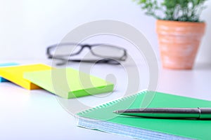 Business concept. Top view of kraft spiral notebook, glasses and pen isolated on background for mockup.