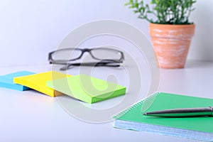 Business concept. Top view of kraft spiral notebook, glasses and pen isolated on background for mockup.