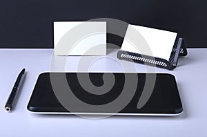 Business concept. Top view of kraft spiral notebook, glasses, smartphone and black pen on background for mockup.