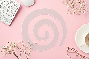 Business concept. Top view photo of workplace keyboard computer mouse cup of coffee saucer stylish glasses and white gypsophila