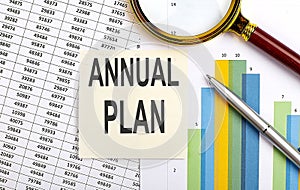 Business concept. Top view of stiscker with text ANNUAL PLAN on chart background