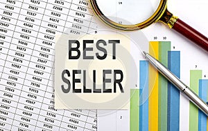 Business concept. Top view of stiscker with text BEST SELLER on chart background