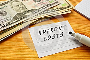 Business concept about UPFRONT COSTS with sign on the sheet photo