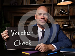 Business concept about Voucher Check with sign on blank notepad
