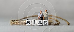 Business concept with white cube arranged in the word  Ã¢â¬â¢BIAS` and miniature people. photo