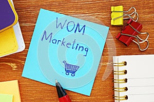 Business concept about Word-of-Mouth Marketing WOM Marketing with inscription on the sheet