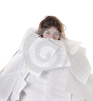 Business concept:young woman drowning in papers