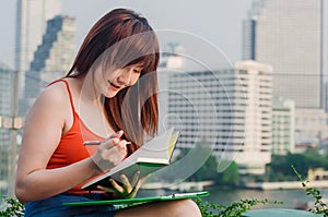 Business Concepts. Asian business woman are reading and writing books.