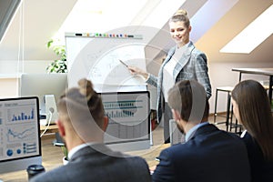 Business conference presentation with team training flipchart office