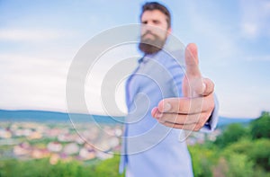 Business connections. Hand of businessman offer hand for handshake blue sky background. Handshake friendly gesture or