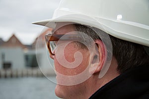 Business construction man ingineer architect on the work site overlooking project at waterfront