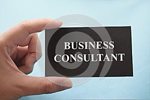 Business consultant, text words typography written on paper against blue background, life and business motivational inspirational