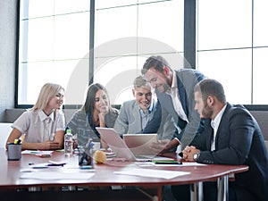 Business consultants while working in a team.A group of young workers at a meeting in the company conference room