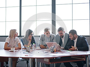 Business consultants while working in a team. A group of young workers at a meeting in the company conference room