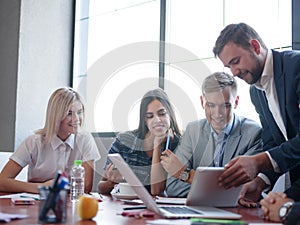 Business consultants while working in a team.A group of young workers at a meeting in the company conference room