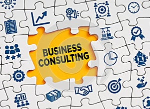 Business consulting concept. The word business consulting in a missing puzzle piece with business symbols