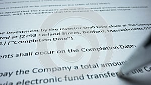 Business contract terms on paper sheet. Closeup person signing document with pen