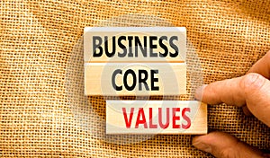 Business core values symbol. Concept words Business core values on wooden block. Beautiful canvas background. Businessman hand.