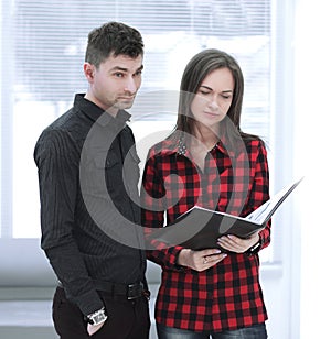 Business couple with clipboard discussing working issues