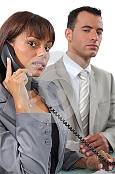 Business couple making a call