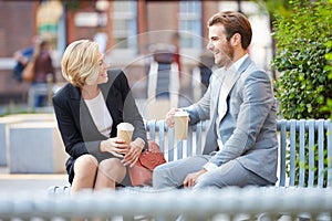 Business Couple On Park Bench With Coffee