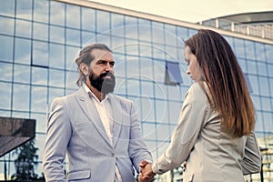 business couple shaking hands. bearded man meet woman outdoor. business meeting.