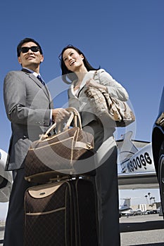 Business Couple Standing At Airfield