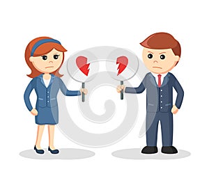 Business couple standing with broken heart sign